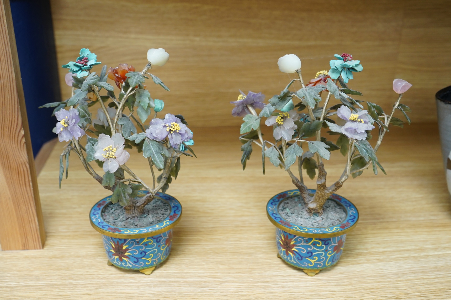 A pair of Chinese hardstone trees, in cloisonne jardinieres, 23cm high